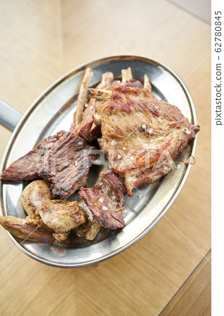 Various grilled meat set heated on coals. Barbecue restaurant menu. Many different food on the table. Dinner party or Banquet Various grilled meat set heated on coals. Barbecue restaurant menu. Many different food on the table. Dinner party or Banquet 62780845