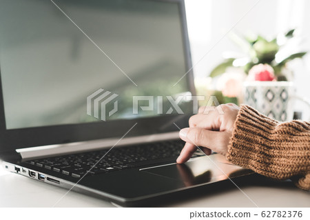 Woman hand using laptop or smartphone to work Woman hand using laptop or smartphone to work 62782376