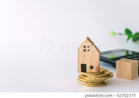 Mini house model on gold coin with clean white Mini house model on gold coin with clean white 62782377