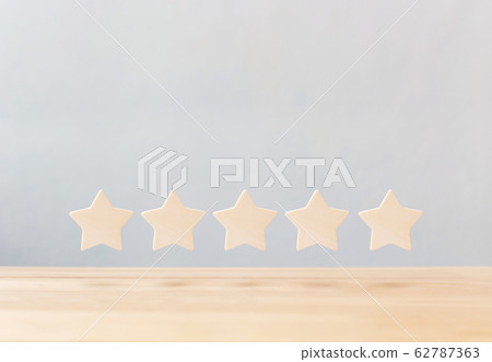 Wooden five star shape on table. The best excellent business rating customer experience concept 62787363