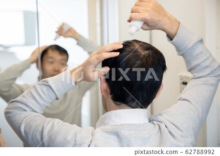 Middle aged man suffering thin hair Middle aged man suffering thin hair 62788992