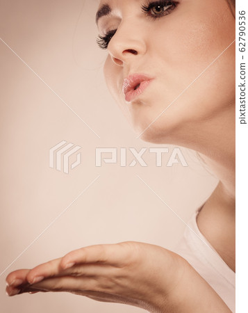 Happy woman sending air kisses 62790536