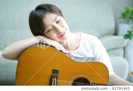 Woman with acoustic guitar Woman with acoustic guitar 62791445