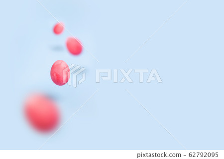 Flying pink chicken eggs on a blue background 62792095