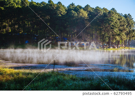 Beautiful natural landscape with fog floating on the lake surface Beautiful natural landscape with fog floating on the lake surface 62793495