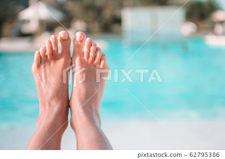 Female feet outdoors during summer vacation near pool 62795386