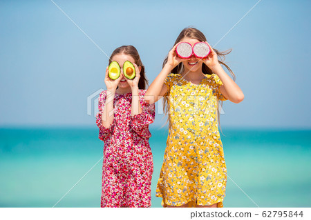Cute little girls at beach during summer vacation Cute little girls at beach during summer vacation 62795844
