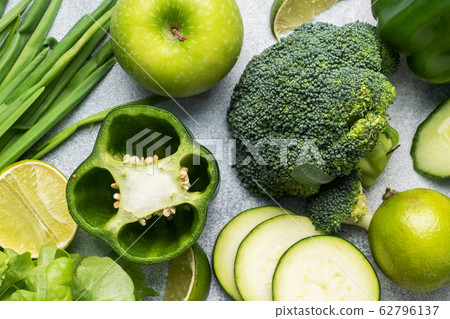 Fresh green vegetables and herbs on a grey Fresh green vegetables and herbs on a grey 62796137