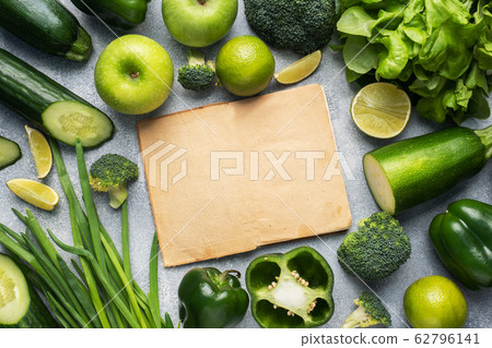 Frame Fresh green vegetables and herbs on a grey Frame Fresh green vegetables and herbs on a grey 62796141