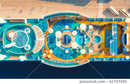 Aerial view of luxury cruise liner. Top view of swimming pool,sunbeds, umbrellas on the cruise ship Aerial view of luxury cruise liner. Top view of swimming pool,sunbeds, umbrellas on the cruise ship 62797895