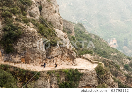 Aerial view of hiking family with dog on Montserrat Mountains 62798112