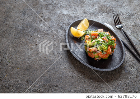 PERUVIAN NIKKEI FOOD. Salmon avocado ceviche on PERUVIAN NIKKEI FOOD. Salmon avocado ceviche on 62798176