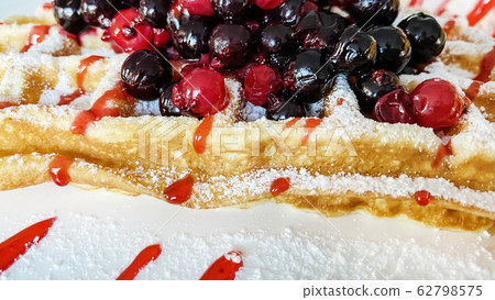 Belgian waffles with fresh berries and ice cream Belgian waffles with fresh berries and ice cream 62798575