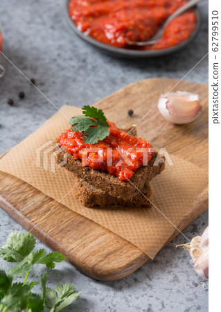 Slice of rye bread toast with ajvar or harissa Slice of rye bread toast with ajvar or harissa 62799510
