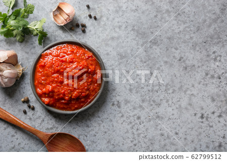 Tasty ajvar. Vegetable sauce of baked red pepper Tasty ajvar. Vegetable sauce of baked red pepper 62799512