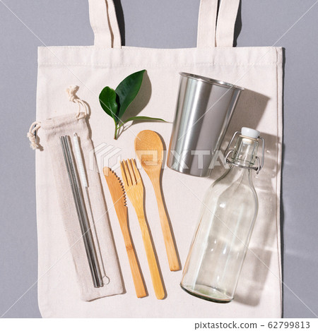 Fabric bags, glass jars, metal straws, bamboo cutlery on grey background with copy space. Eco friendly and reuse concept. Top view. Flat lay. Zero waste concept 62799813