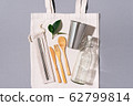 Zero waste concept. Textile eco bags, glass jars and bamboo cutlery on grey background with copy space. Eco friendly and reuse concept. Top view. Flat lay 62799814