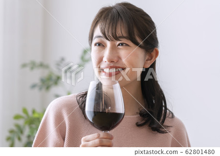 A woman with a wine glass A woman with a wine glass 62801480