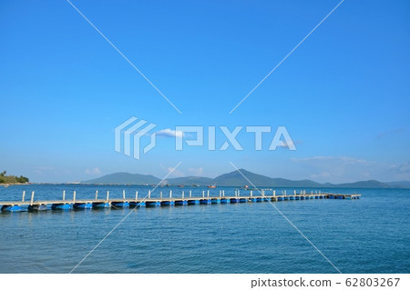 A floating bridge on the bay of Van Phong, Khanh Hoa, Vietnam with blue sea and sky 62803267