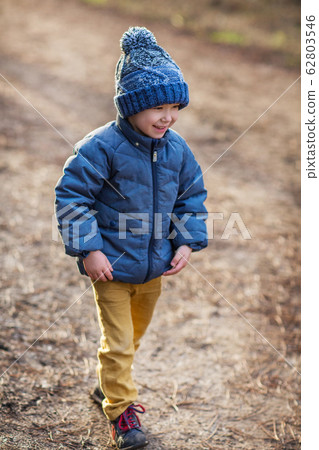 Cheerful preschool kid outdoors 62803546