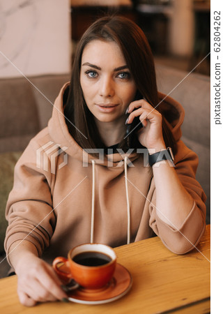 Middle shot portrait of young woman in casual clothes talking on the phone 62804262
