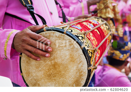 Bali background. Balinese man play on traditional Bali background. Balinese man play on traditional 62804620