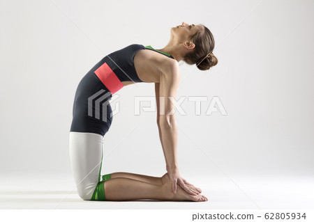 Young woman doing camel yoga pose Young woman doing camel yoga pose 62805934