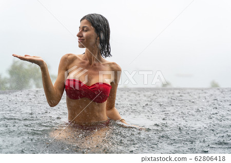 Girl in a red bra sitting in the water 62806418