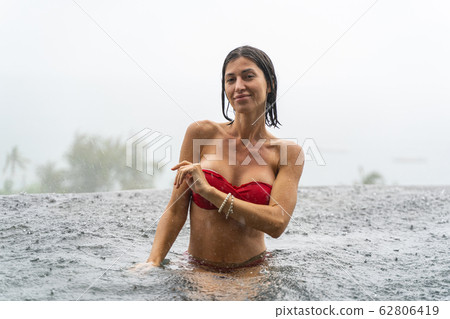 Attractive female tourist looking in front of her Attractive female tourist looking in front of her 62806419