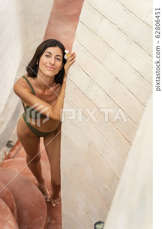 Joyful barefoot Caucasian lady standing on the stone steps 62806451