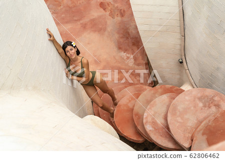 Lovely lady in a stylish bikini standing outdoors 62806462