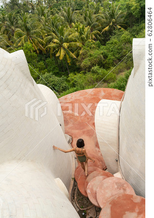 Girl leaning against the wall with one hand 62806464