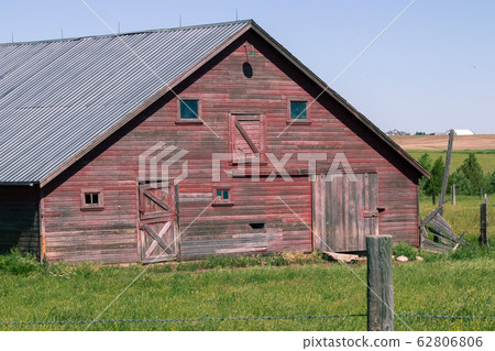 An old abandoned barn in a field An old abandoned barn in a field 62806806