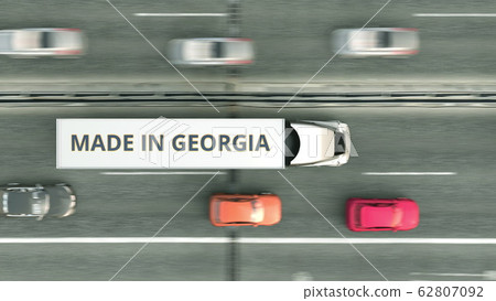 Trailer truck with MADE IN GEORGIA text driving along the road. Georgian business related 3D rendering Trailer truck with MADE IN GEORGIA text driving along the road. Georgian business related 3D rendering 62807092