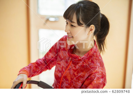 Woman playing fitness game at home 62809748