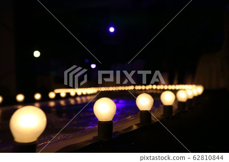 Empty Runway Fashion Show with Ball glowing lighting along walk way with plastic white floor in the dark Empty Runway Fashion Show with Ball glowing lighting along walk way with plastic white floor in the dark 62810844