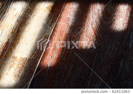 Sunlight from window with bars falling on wooden 62811063