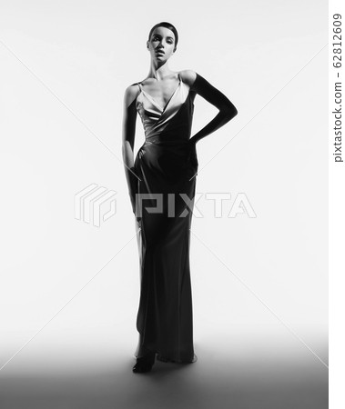Beautiful woman pose in studio in classic dress 62812609