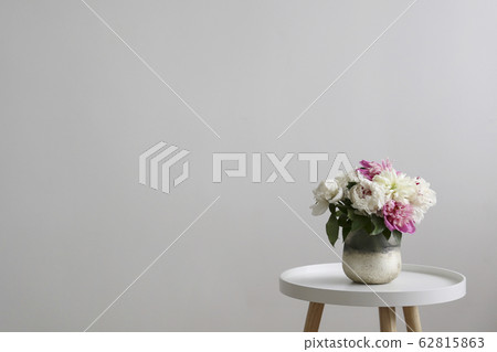 Beautiful peony flowers closeup over textured background with a lot of copy space for text. International women's mother's valentine's first spring day. Close up, top view, backdrop, flat lay. Beautiful peony flowers closeup over textured background with a lot of copy space for text. International women's mother's valentine's first spring day. Close up, top view, backdrop, flat lay. 62815863
