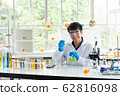 Science, Chemistry, Technology, Biology and Laboratory concept - Asian junior scientist so glad and smile happiness for experiment result in flask. 62816098