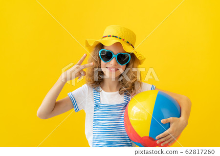 Portrait of happy child against yellow background Portrait of happy child against yellow background 62817260