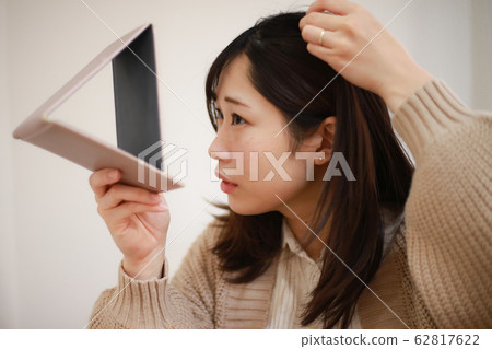 A woman who cares about her hair A woman who cares about her hair 62817622