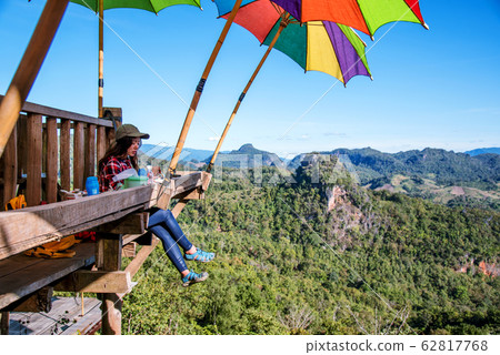 The girl sitting eating noodle in the rural village hanging legs style for viewpoint  62817768