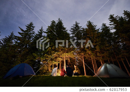 Campfire evening campfire against the backdrop of a powerful forest. Campfire evening campfire against the backdrop of a powerful forest. 62817953