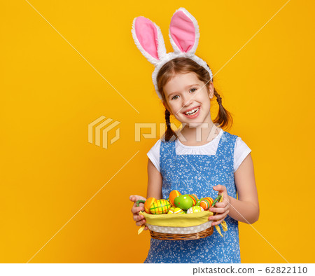 funny happy child girl with easter eggs and bunny 62822110