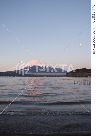 Red Fuji (winter) at dawn as seen from Lake Yamanaka (near the plains) Red Fuji (winter) at dawn as seen from Lake Yamanaka (near the plains) 62825476