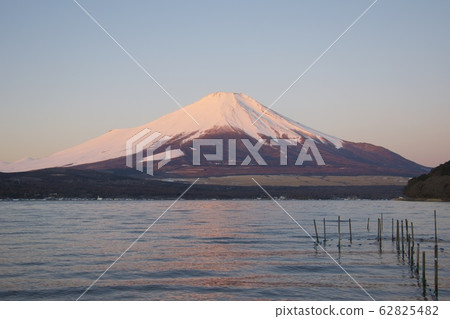 Red Fuji (winter) at dawn as seen from Lake Yamanaka (near the plains) Red Fuji (winter) at dawn as seen from Lake Yamanaka (near the plains) 62825482