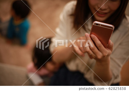 Mother who is obsessed with smartphone operation Mother who is obsessed with smartphone operation 62825838