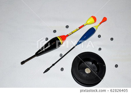 Floats, sinkers, hooks and reel with fishing line on the table. Floats, sinkers, hooks and reel with fishing line on the table. 62826405