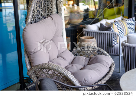 Closeup Empty hanging wicker Comfortable chair Closeup Empty hanging wicker Comfortable chair 62828524